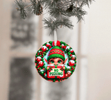 Christmas ornament with elf holding a 'No Peeking' sign, hanging on a tree.