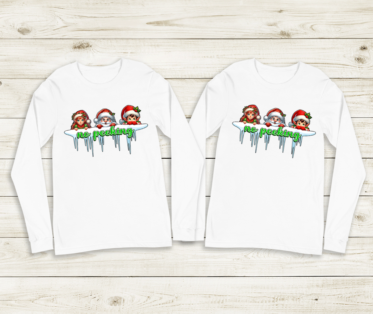 Two white long-sleeve shirts with Christmas-themed design on a wooden surface