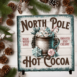 Decorative sign for hot cocoa with festive elements on a wooden background