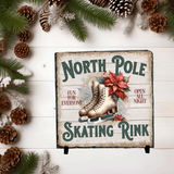 Decorative sign for a North Pole skating rink with ice skates and poinsettias on a wooden background.