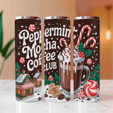 Three Peppermint Mocha Coffee Club tumblers with festive design on a blurred background