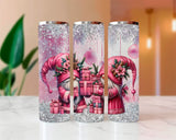 Three glittery tumblers with pink gnome design on a marble surface.