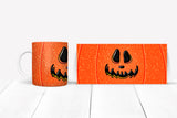 Orange mug  with jack-o'-lantern design on a white surface