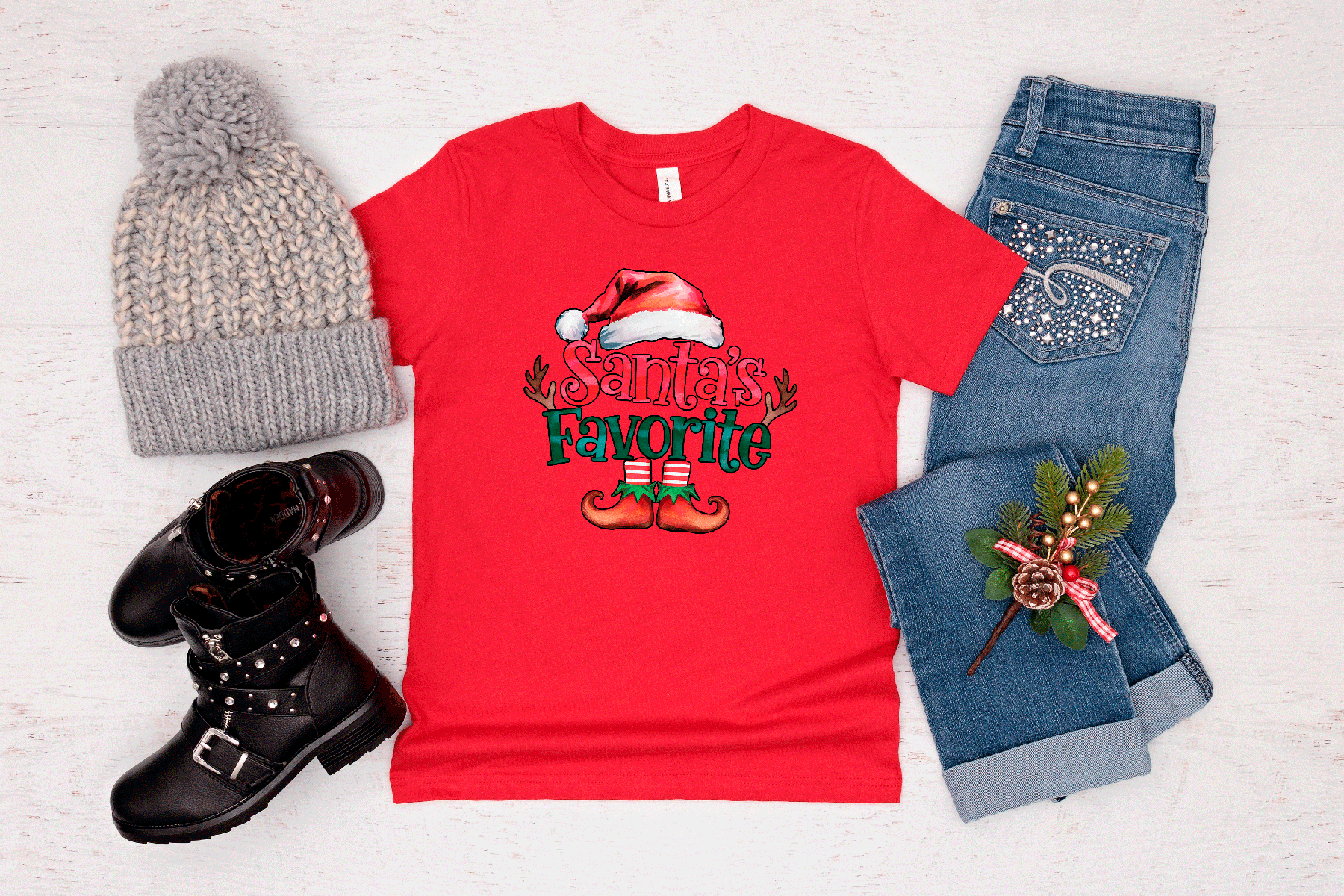 Red t-shirt with 'Santa's Favorite' design, gray beanie, black boots, and jeans on a light background