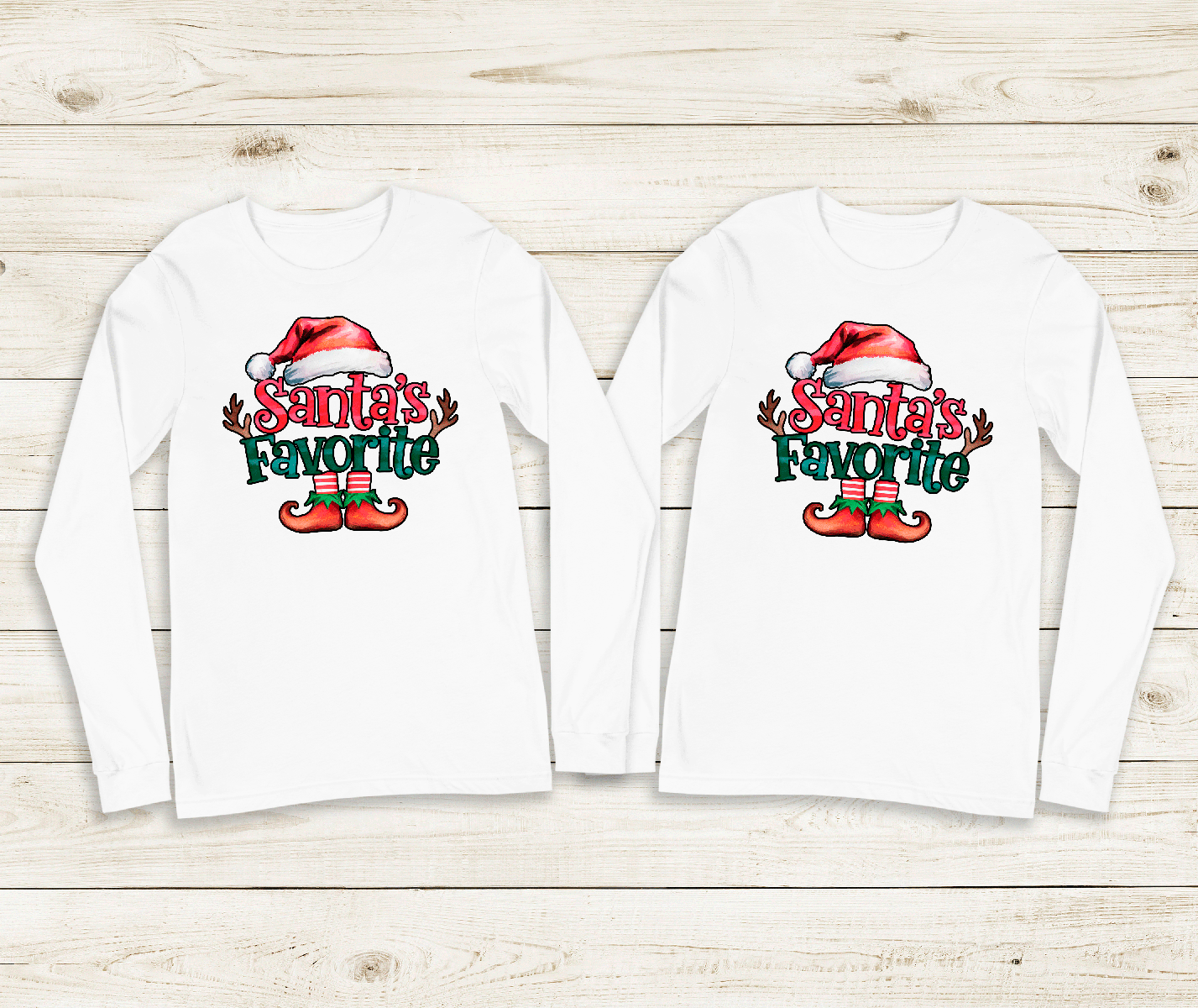 Two white long-sleeve shirts with 'Santa's Favorite' text and elf design on a wooden surface.