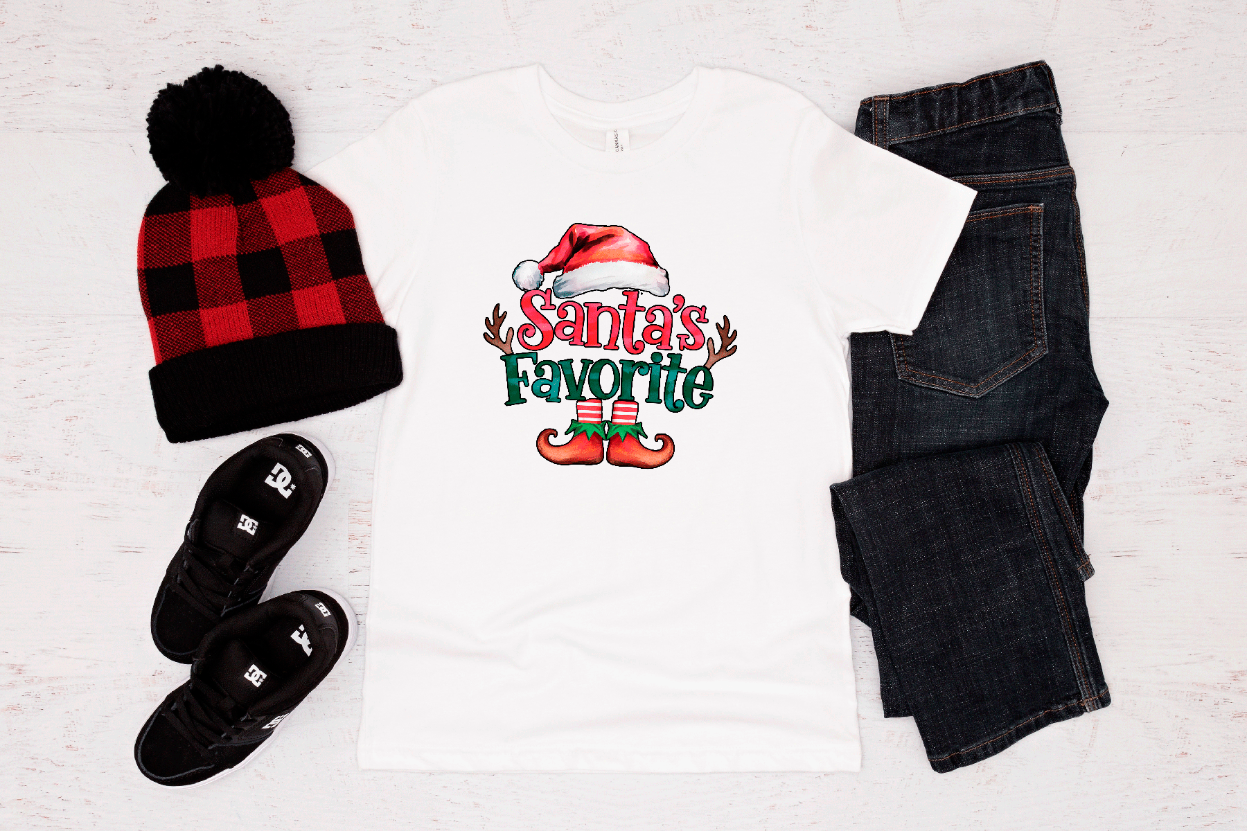Holiday-themed outfit with beanie, shirt, jeans, and shoes on a white background