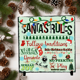 Christmas-themed sign with 'Santa's Rules' on a decorative background with pine cones and greenery.