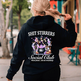 Person wearing a black hoodie with Halloween-themed design and text.