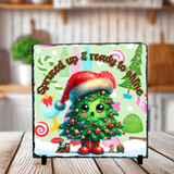 Decorative plaque with a Christmas tree design and festive text on a stand.
