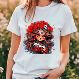 Person wearing a white t-shirt with a colorful graphic design of a woman with flowers and skulls.