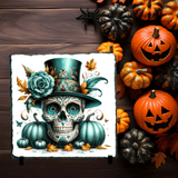 Decorative skull with teal top hat and flowers surrounded by pumpkins on a wooden background