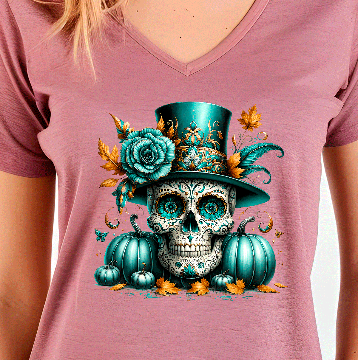 Pink t-shirt with a colorful skull design featuring teal hat, flowers, and pumpkins on a white background.