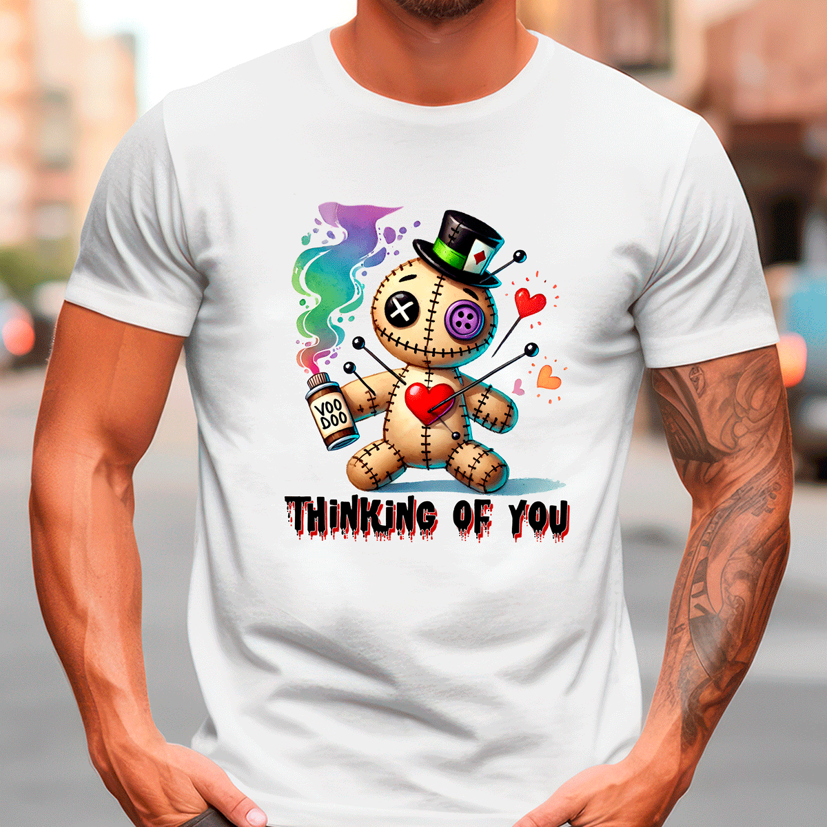 White t-shirt with a colorful graphic design of a teddy bear and text 'Thinking of You' worn by a person.
