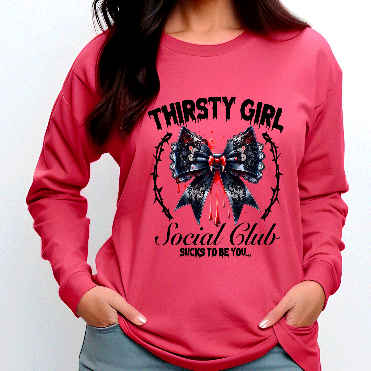 Pink sweatshirt with a black bow graphic and text on a white background
