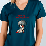 Person wearing a teal t-shirt with a graphic design of a voodoo doll and text.