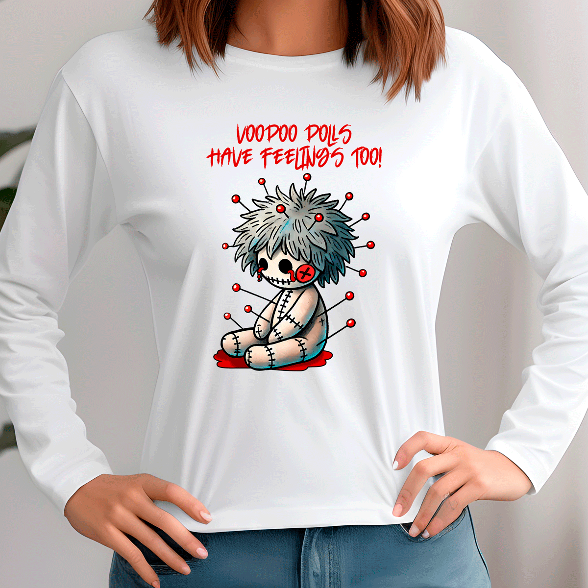 White long-sleeve shirt with a cartoon voodoo doll design and text on a plain background