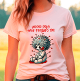 Person wearing a pink t-shirt with a voodoo doll graphic and text.