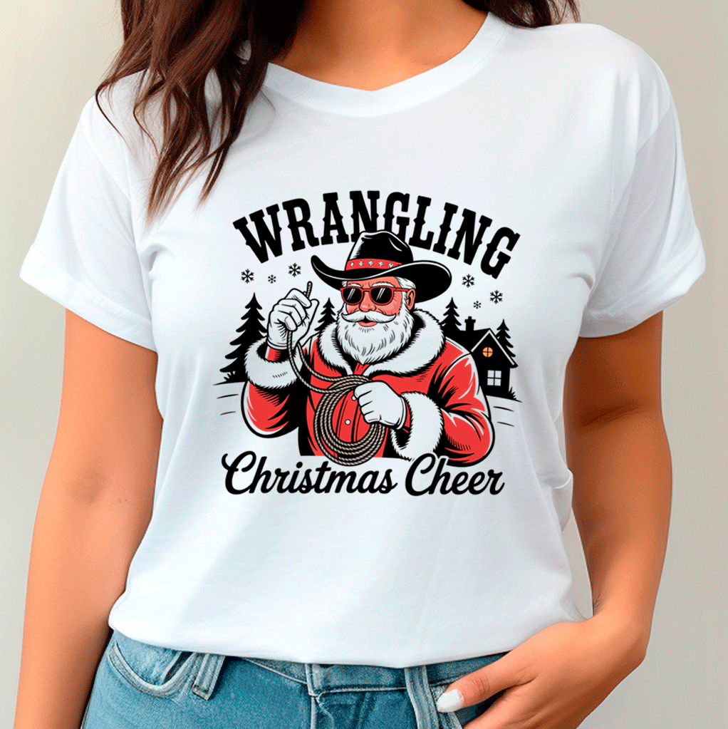 White t-shirt with a graphic of a Santa Claus holding a rope and text 'Wrangling Christmas Cheer' worn by a person.