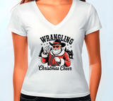White t-shirt with a graphic of a Santa Claus wearing a cowboy hat and sunglasses, with text 'Wrangling Christmas Cheer' on a white background.